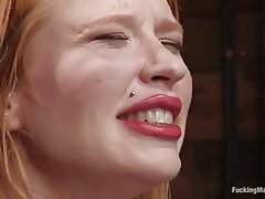 Madison Young is rubbing her clit like crazy while a fucking machine is drilling her pussy