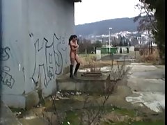 Dark haired slut is sucking dick in a public place, while no one is watching her