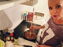 Great blonde chick in black boots is sitting on the chair and rubbing her juicy slit