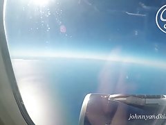 Naughty blonde is rubbing and sucking her boyfriend's dick, while they are in the plane