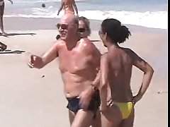 Oiled girls are not wearing their tops on the beach, because they like showing their tits